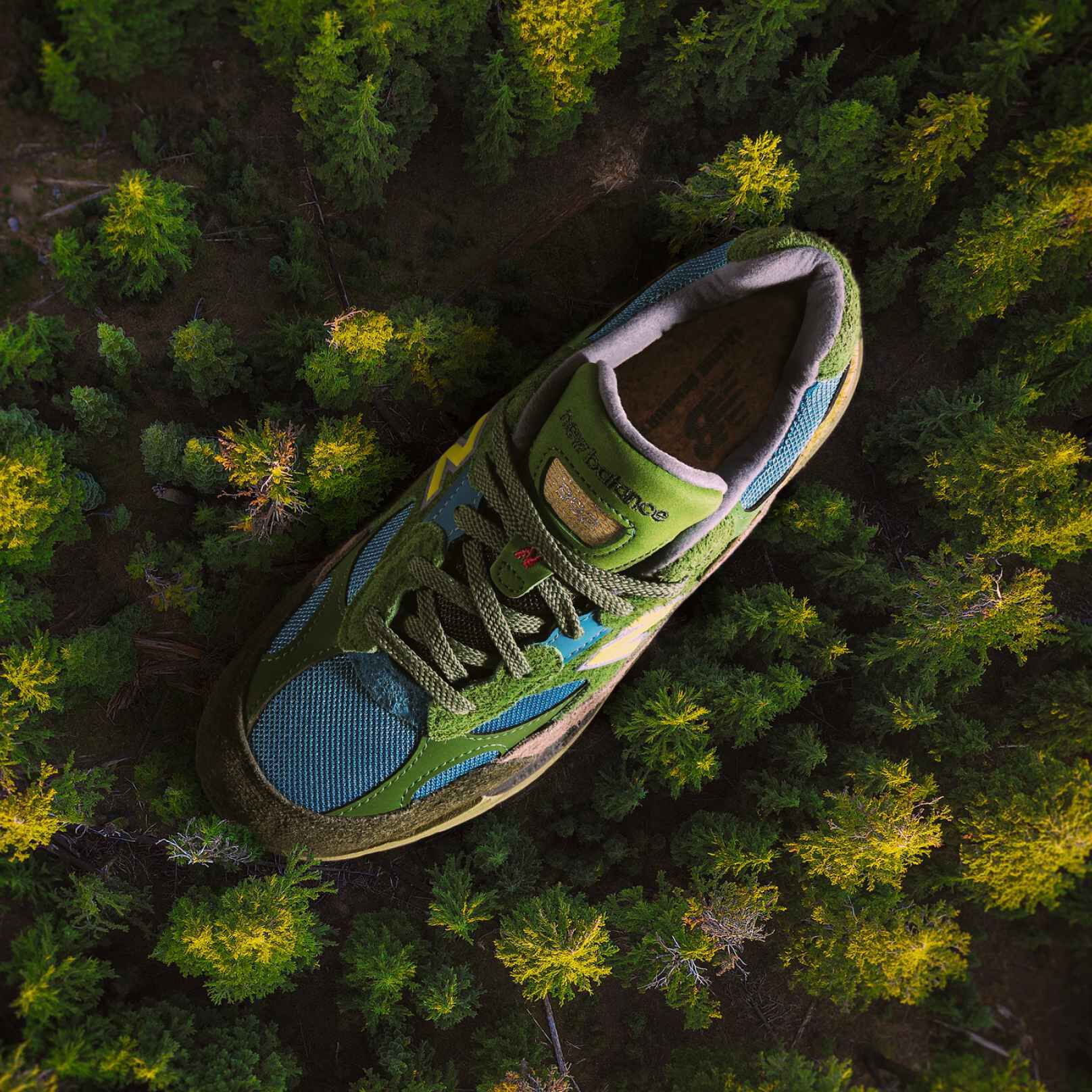 Two people posing indoors against a textured backdrop, wearing casual athletic outfits and sneakers. 
